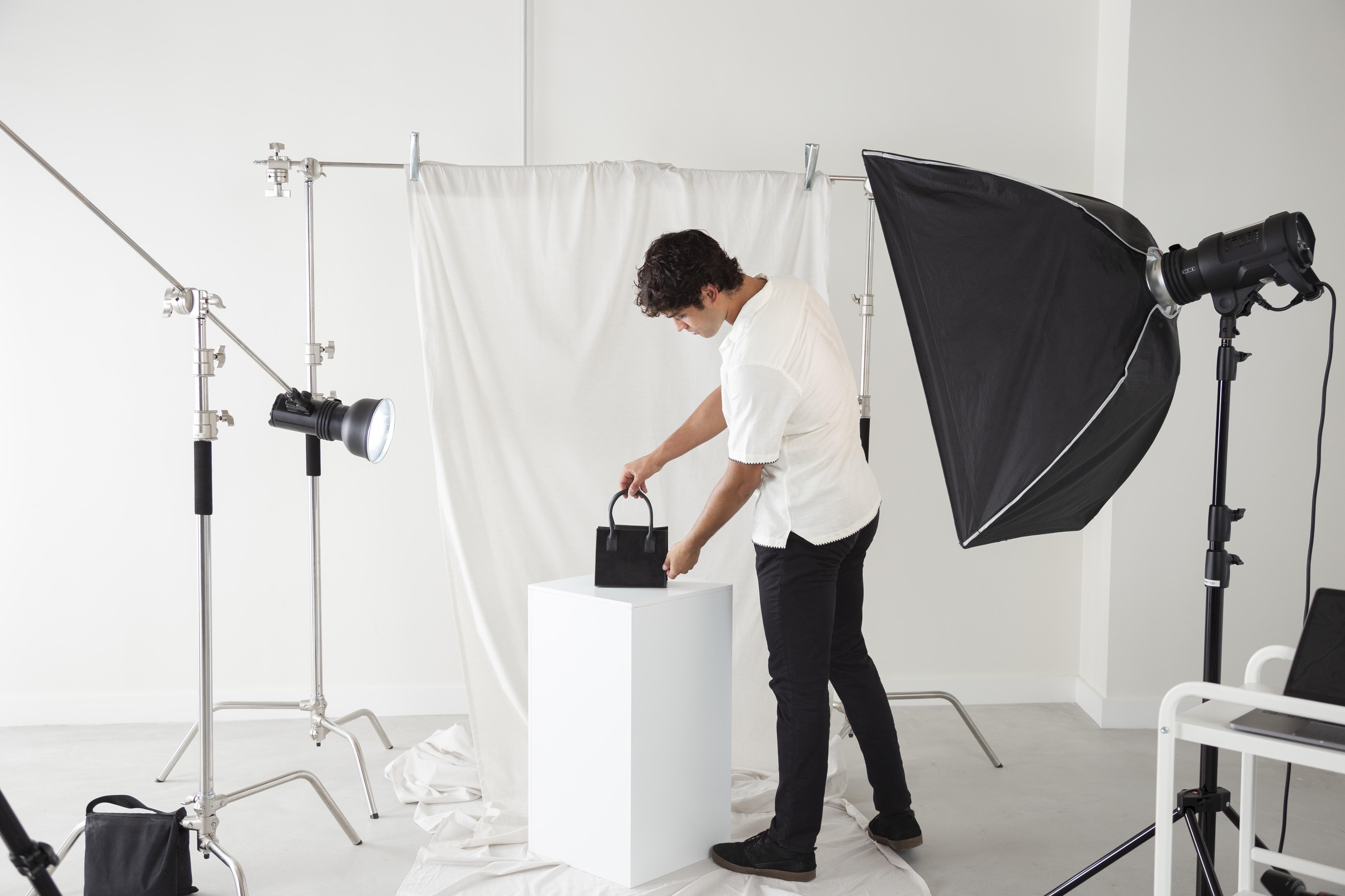 young man working his photography studio